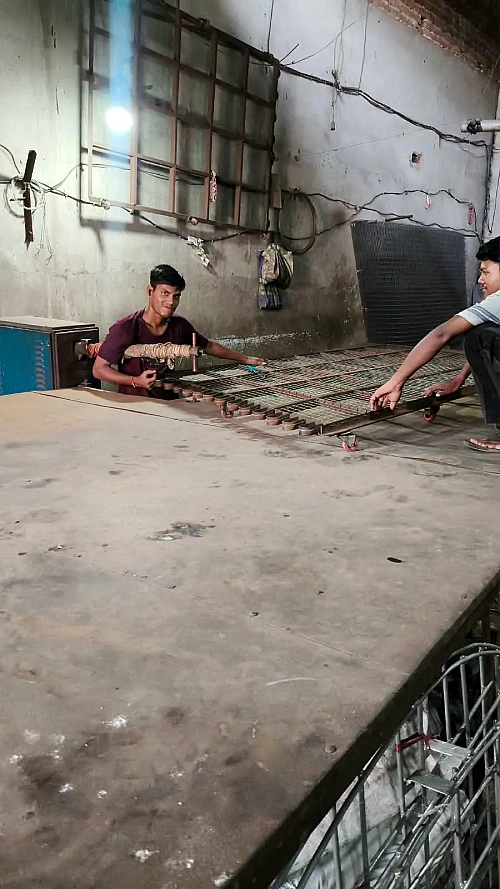 Workers fabricating cooling tower components on the shop floor
